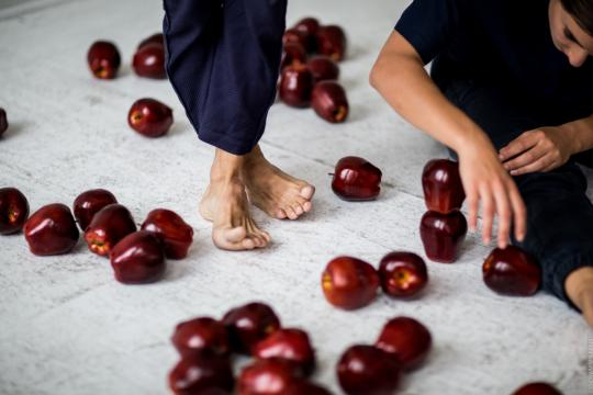 Apples are used as props during the dance performance. / Image via Maria Baranova, used with permission.