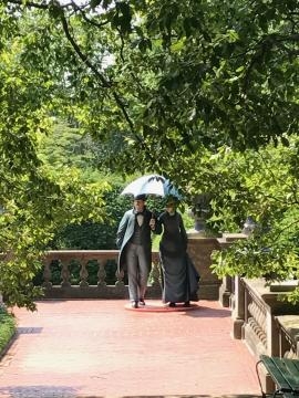 Two life-like sculptures seeming strolling along at Old Westbury Gardens. / Photo via the Seward Johnson Atelier, used with permission.