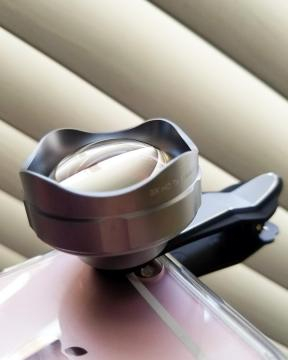 The Aukey Zoom Optical Lens clipped on an iphone 6s (Photo Credit: Odette Perez)