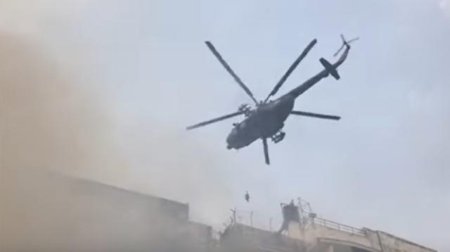 Many feared trapped as people escape Dhaka office building fire. [Image source/Guardian News YouTube video]
